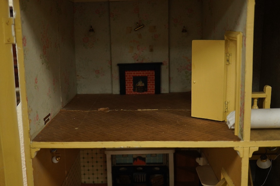 A modern ‘Vine House’ dolls house with furniture and accessories; a large six room house with hall and stairwell, the front wall opening in two sections on hinges each side, with internal decoration and lighting, width 1
